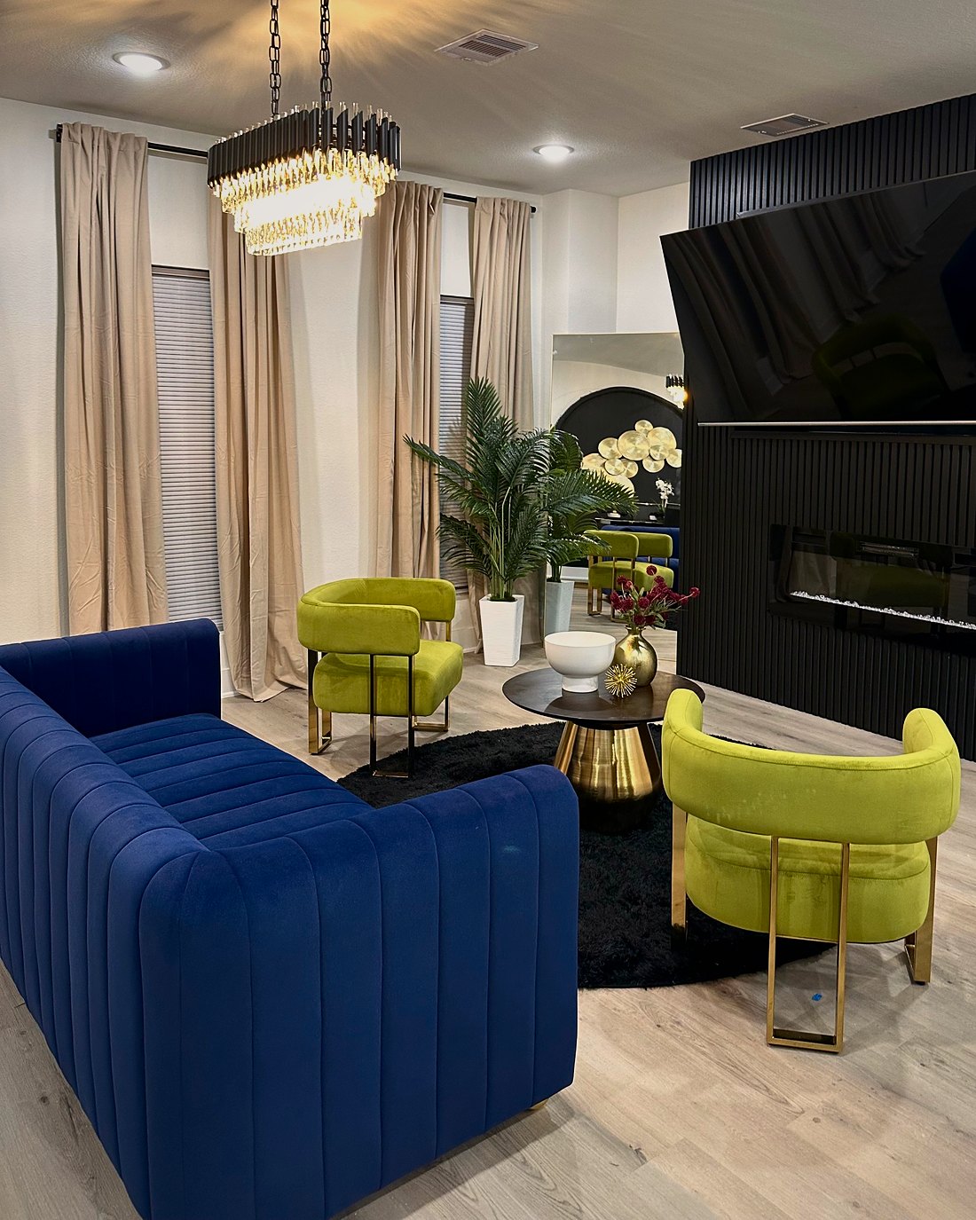 Navy and chartreuse seating with layered curtains and brass accents